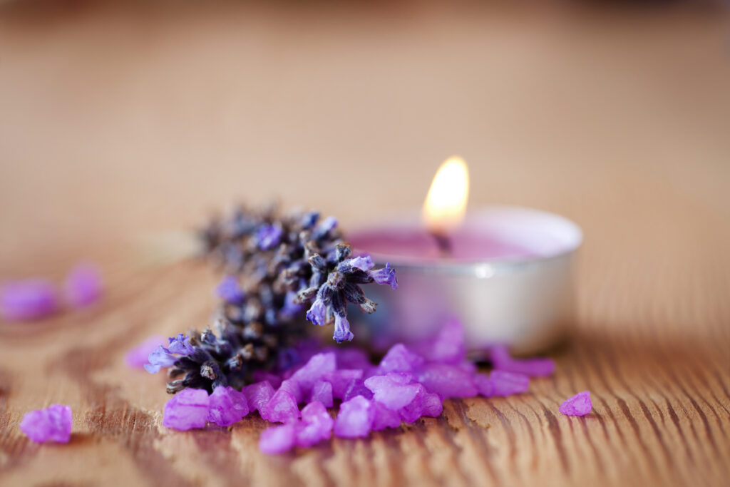 Spa background, handmade candle with salt baths and sprigs of lavender