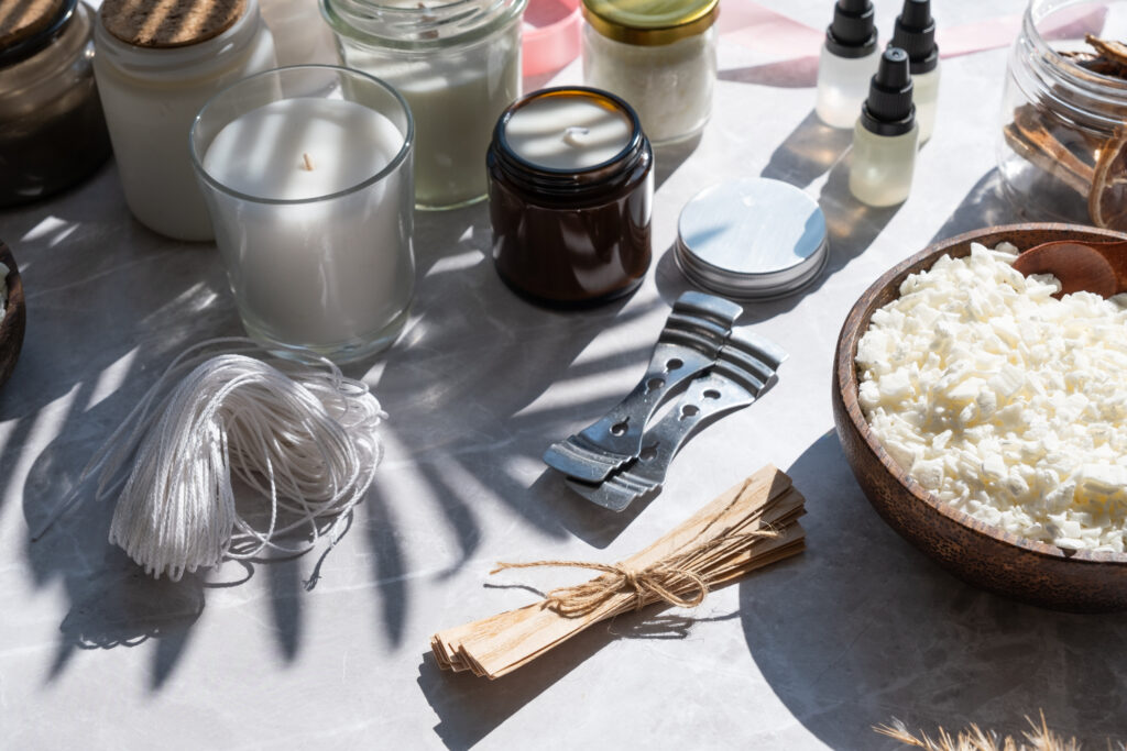 Set for crafting candle on white wooden background. Eco soy wax and candle making tools top view, flat lay. DIY candles. Hobby concept.