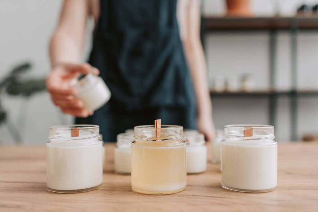 wooden candle wicks being used to make candles