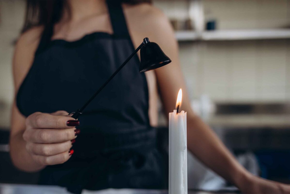 candle snuffer in use